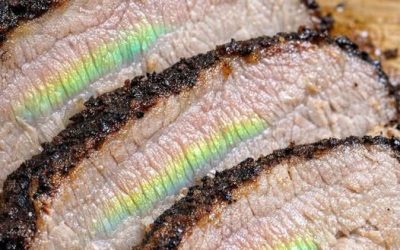 I slow cooked a pork roast for 8 hours, but when I sliced it, I saw this weird shiny green and rainbow reflection on the meat fibers. It looks like gasoline on water. Did the meat go bad?